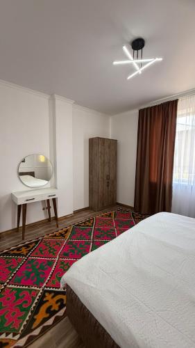 TongAgat cottage的卧室里有一张床、一张桌子和一面镜子