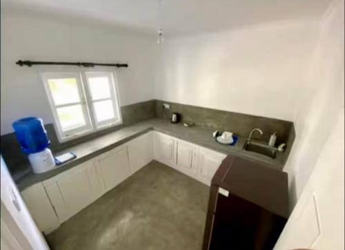 a kitchen with a sink and a window at Coco Cabana Kite Resort Kalpitiya in Kalpitiya