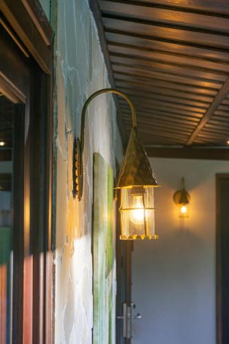 a light hanging on the side of a wall at Palm Garden Beach Resort & Spa in Hoi An