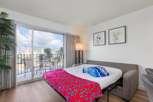 a bedroom with a bed and a large window at 01 FREE Parking 10 min beach 2br-Waikiki Ala Moana in Honolulu