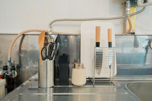 a kitchen counter with a sink with utensils at Birch&Lake in Teshikaga