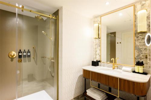 a bathroom with a sink and a shower at Hotel Saski Krakow Curio Collection by Hilton in Kraków