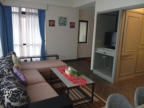 a living room with a couch and a table at Fantastic appartment at times square Kuala Lumpur in Kuala Lumpur