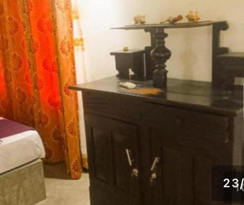 a room with a bed and a black dresser at Coco Cabana Kite Resort Kalpitiya in Kalpitiya