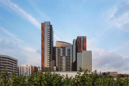 a city skyline with tall skyscrapers at DoubleTree by Hilton Dubai M Square Hotel & Residences in Dubai