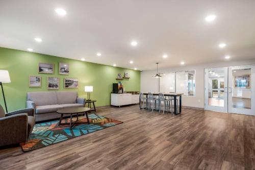 a living room with a couch and a table at WoodSpring Suites Tampa Airport North Veterans Expressway in Tampa