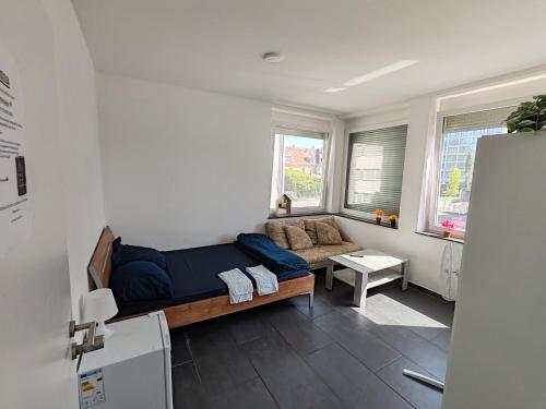a bedroom with a bed and a couch in a room at Anna Zimmer Zentral Günstig in Heilbronn