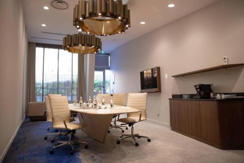 a large dining room with a table and chairs at Clarion Paris CDG Airport in Roissy-en-France