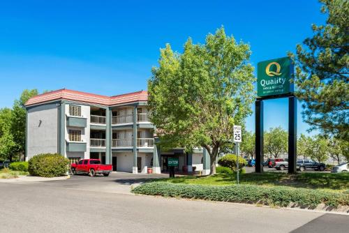 a sign for a quality hotel in a parking lot at Quality Inn & Suites Sunport Airport Albuquerque in Albuquerque