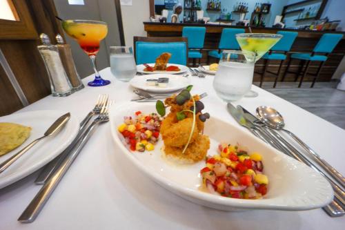 a table with a plate of food on a table at Comfort Inn & Suites Tobago in Tobago Island
