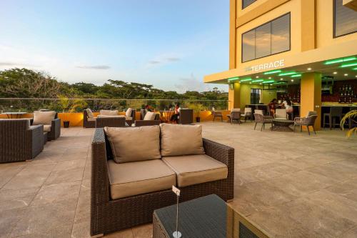a couch sitting on a patio in front of a building at Comfort Inn & Suites Tobago in Tobago Island
