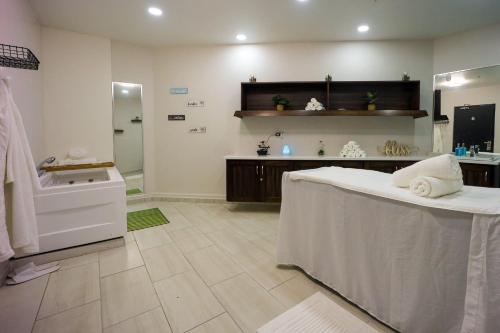 a large bathroom with a tub and a sink at Comfort Inn & Suites Tobago in Tobago Island
