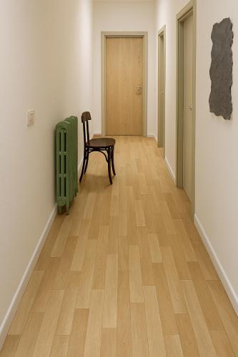 a hallway with a chair and a wooden floor at Baita Cao Como Lake in Brunate
