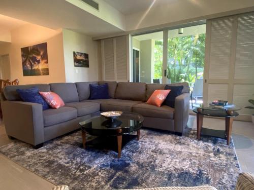 a living room with a couch and two tables at Waikoloa Beach Condo in Waikoloa