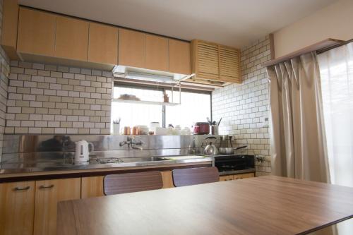 a kitchen with a sink and a counter top at Matsuyama - House / Vacation STAY 57590 in Matsuyama