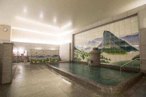 a swimming pool in a room with a painting on the wall at Matsuyama - House / Vacation STAY 57590 in Matsuyama