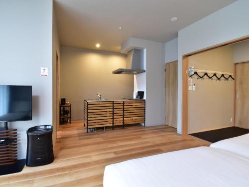 a hotel room with a bed and a television at Rakuten STAY MOTEL Kujukurihama Katakai 101 1LDK with BBQ terrace pet allowed in Kujukuri