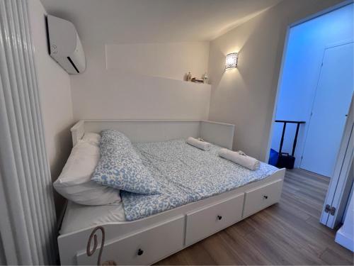 a small bedroom with a white bed with pillows at Il nido della rondine in Ostra