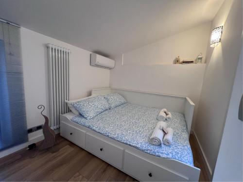 a bedroom with a bed with two teddy bears on it at Il nido della rondine in Ostra