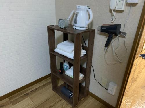 a shelf with a coffee maker and a phone at AO Dazaifu - Vacation STAY 93787 in Chikushino