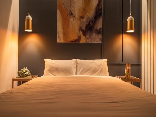 a bedroom with a white bed with two night stands at Naha - House / Vacation STAY 60932 in Naha
