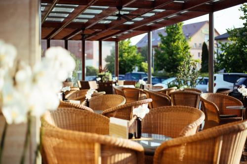 a row of chairs and tables in a restaurant at Hotel Vivat in Moravske Toplice