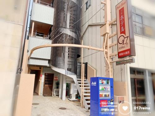 a building with a spiral staircase on the side of it at Petit Hotel 017 / Vacation STAY 67155 in Tokushima