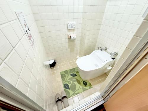 a small bathroom with a toilet in the corner at Petit Hotel 017 / Vacation STAY 67155 in Tokushima