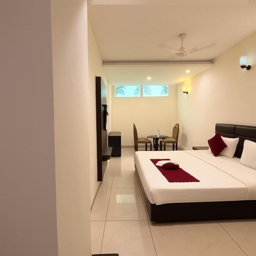 a hotel room with a bed and a table at Hotel JB Residency Zirakpur Chandigarh # Large Rooms # Balcony Rooms # Top Rated in Zirakpur