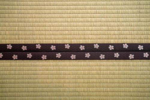 a purple ribbon with white flowers on top of a curtain at Ebisuya / Vacation STAY 5851 in Kofu