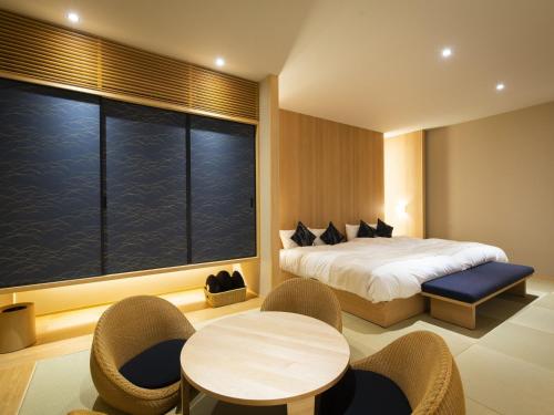 Postel nebo postele na pokoji v ubytování FIRSTCABIN Kyoto Nijojo