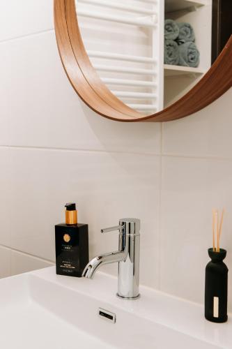 a bathroom sink with a mirror above a sink at Bed and Breakfast Pakhuis Maassluis in Maassluis