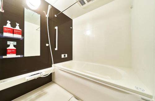 a white bathroom with a tub and a sink at Rakuten STAY HOUSE Kisarazu in Kisarazu