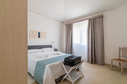 Ένα ή περισσότερα κρεβάτια σε δωμάτιο στο Centenari Longevity Rooms Lotzorai