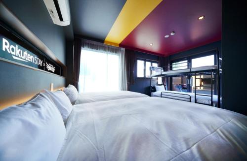 a bedroom with a large white bed in a room at Rakuten STAY x EAGLES 101 with terrace in Sendai