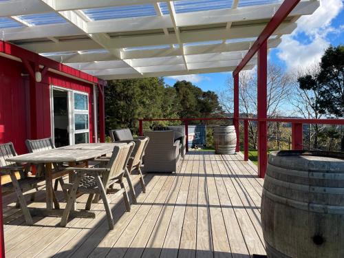 a wooden deck with a table and chairs on it at Highridge View in Clevedon