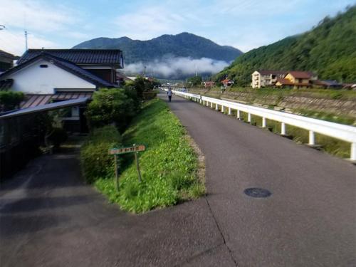 a road with a sign on the side of a mountain at Condominium Tsuwanosou - Vacation STAY 67529v in Tsuwano