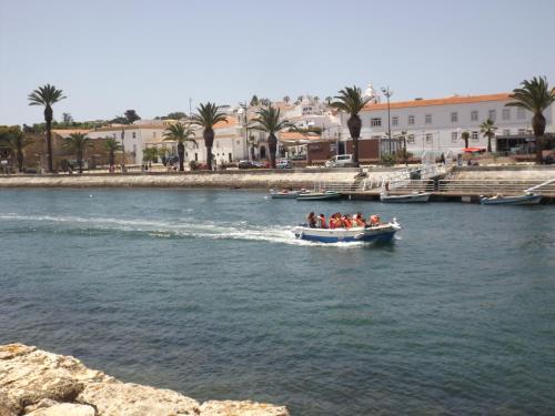 a group of people in a boat on a river at Casas da Barroca in Lagos