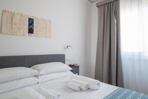Ένα ή περισσότερα κρεβάτια σε δωμάτιο στο Centenari Longevity Rooms Lotzorai