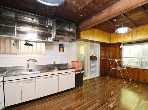 a kitchen with white cabinets and a wooden floor at Villa Ukishima - Vacation STAY 07308v in Naha