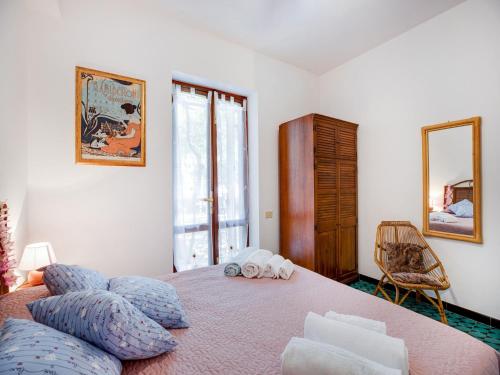 a bedroom with a large bed with blue pillows at Beachfront Villa with Solarium in Siniscola