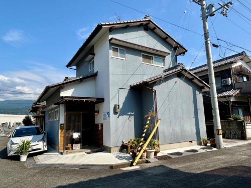 a house with a car parked in front of it at shiokaze guest house / Vacation STAY 6794 in Matsuyama