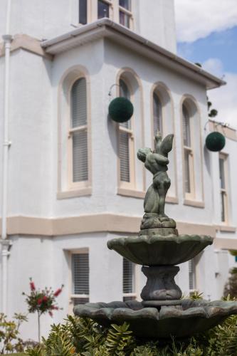 a statue of a fountain in front of a building at Washington House Hotel in Bournemouth