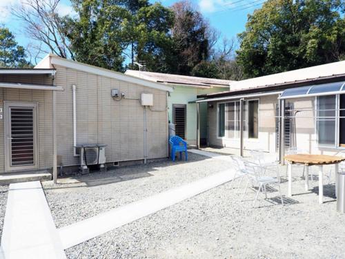 a house with a table and chairs in front of it at olive no sato vingh four eyes shodoshima - Vacation STAY 85255 in Kusakabe