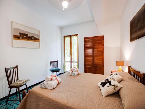 a bedroom with two beds with towels on them at Beachfront Villa with Solarium in Siniscola