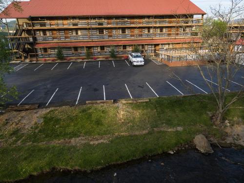 a car parked in a parking lot in front of a building at Timbers Lodge in Pigeon Forge