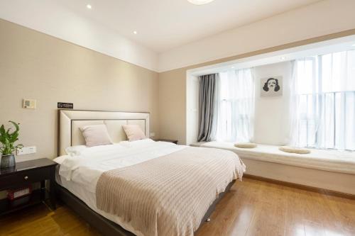 a bedroom with a large bed and a window at Chongqing Forest Design B&B in Chongqing