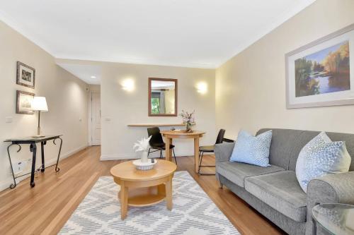 a living room with a couch and a table at Private 1bdr Villa Pinot located within Cypress Lakes Resort in Pokolbin