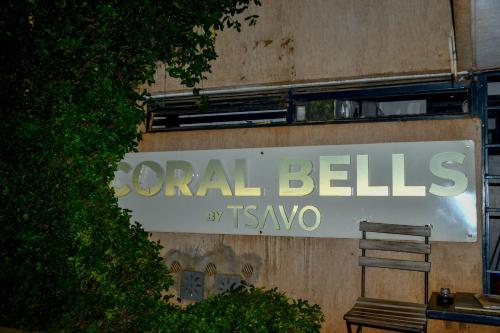 a sign on the side of a building with a bench at Qwetu Luxelite Studio With Rooftop Pool in Nairobi