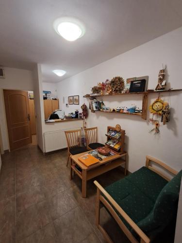 a living room with a table and a couch at Pension Staré Srní in Srní